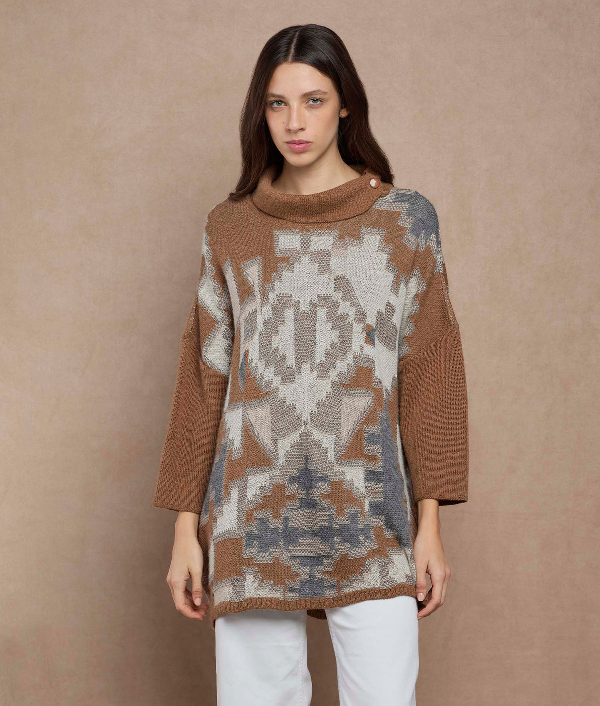 Woman wearing a brown, beige and gray patterned knit sweater.